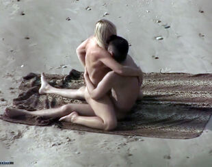 Beach Hunter movie duo toying in the sand.